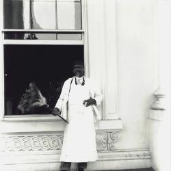 This portrait photograph is of White House staff member Jerry Smith holding his signature feather duster.  Smith started working at the White House during the Ulysses S. Grant administration in the late 1860s, and served as butler, cook, doorman, and footman until his retirement some 35 years later. Shortly before dying at age 69 in 1904, Smith was visited at his home by President Theodore Roosevelt.