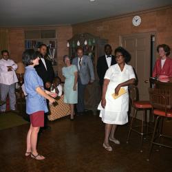 In this photograph from White House Cook Zephyr Wright's birthday party, Fate Suber (third from right) appears to stand directly behind Wright. 